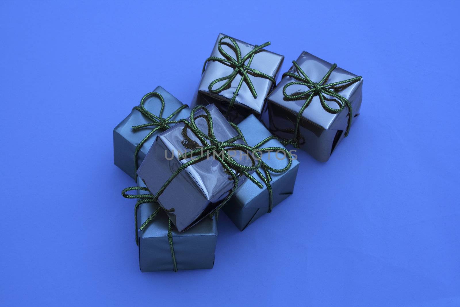 blue coloured boxed square presents fastened with bows