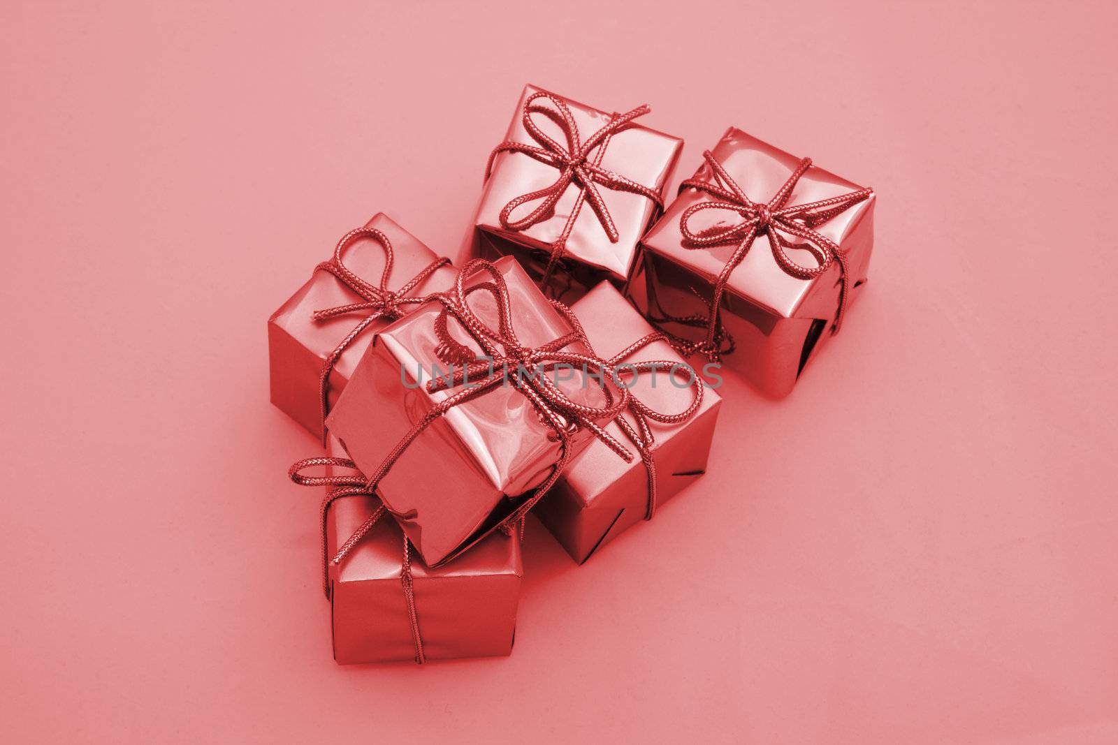 red coloured boxed square presents fastened with bows 