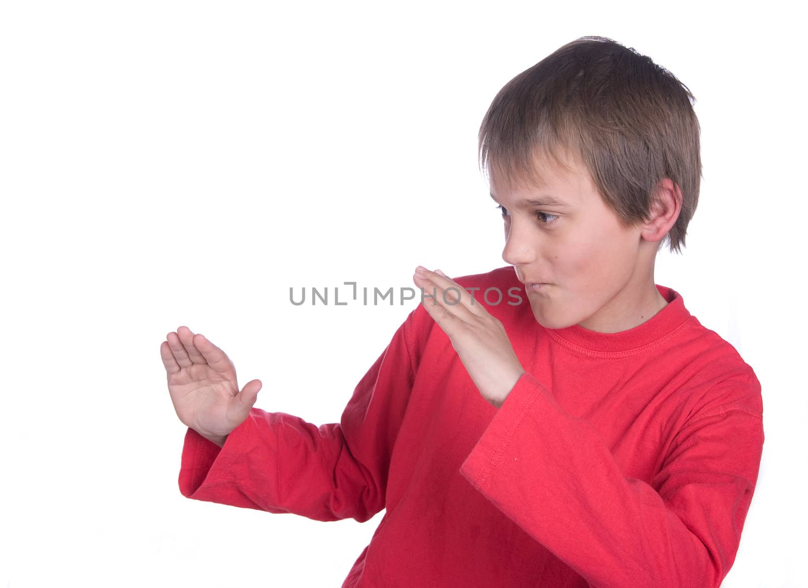 a boy on white background pretending to do martial arts