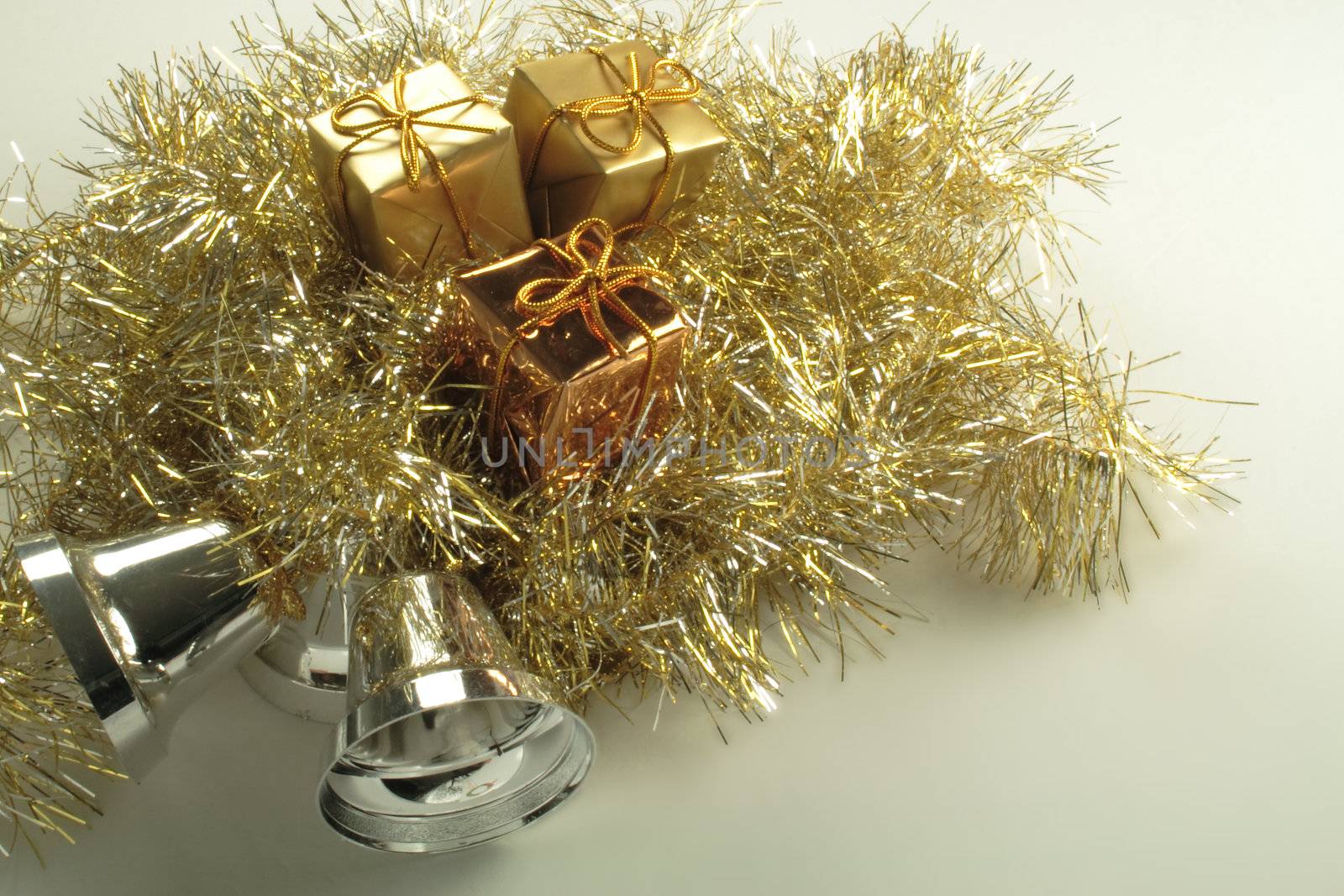 gold present box decorations with golden tinsel by leafy