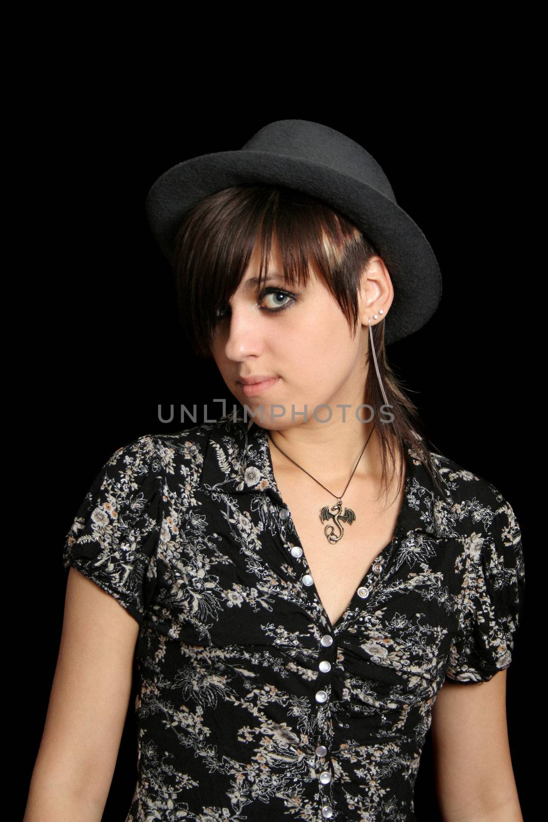 The young girl in a hat, on a black background