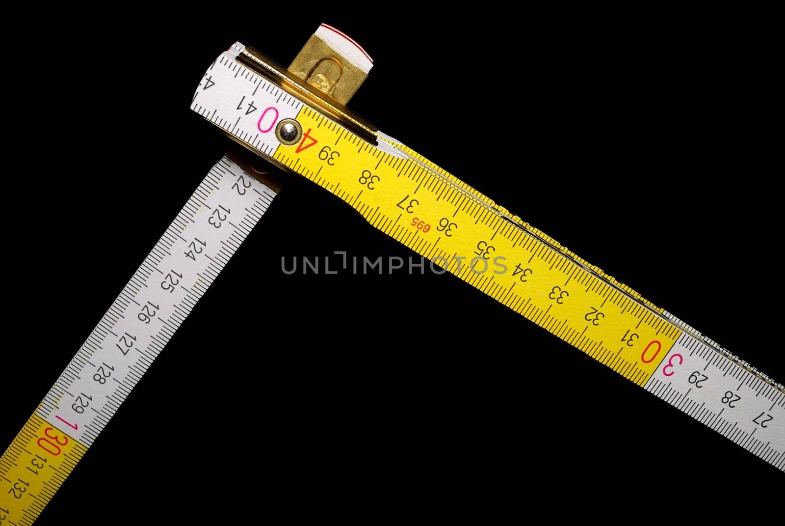 White and yellow yardstick with black background