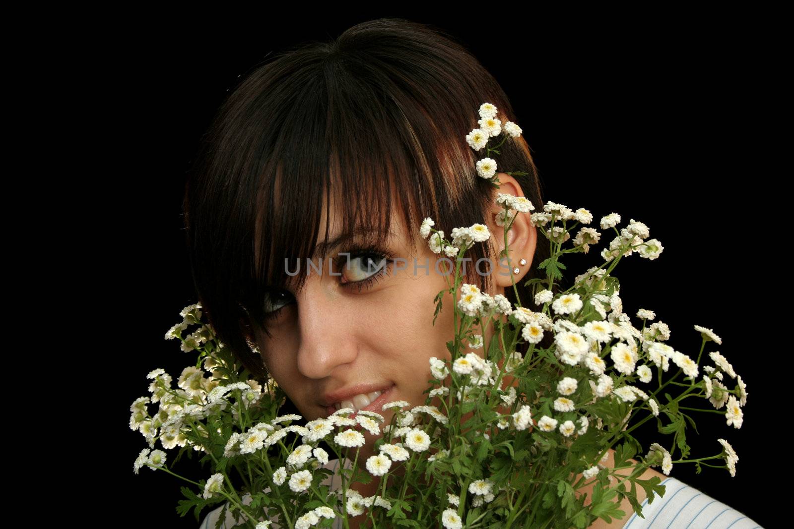 The young beautiful girl with flowers, isolated on a black background