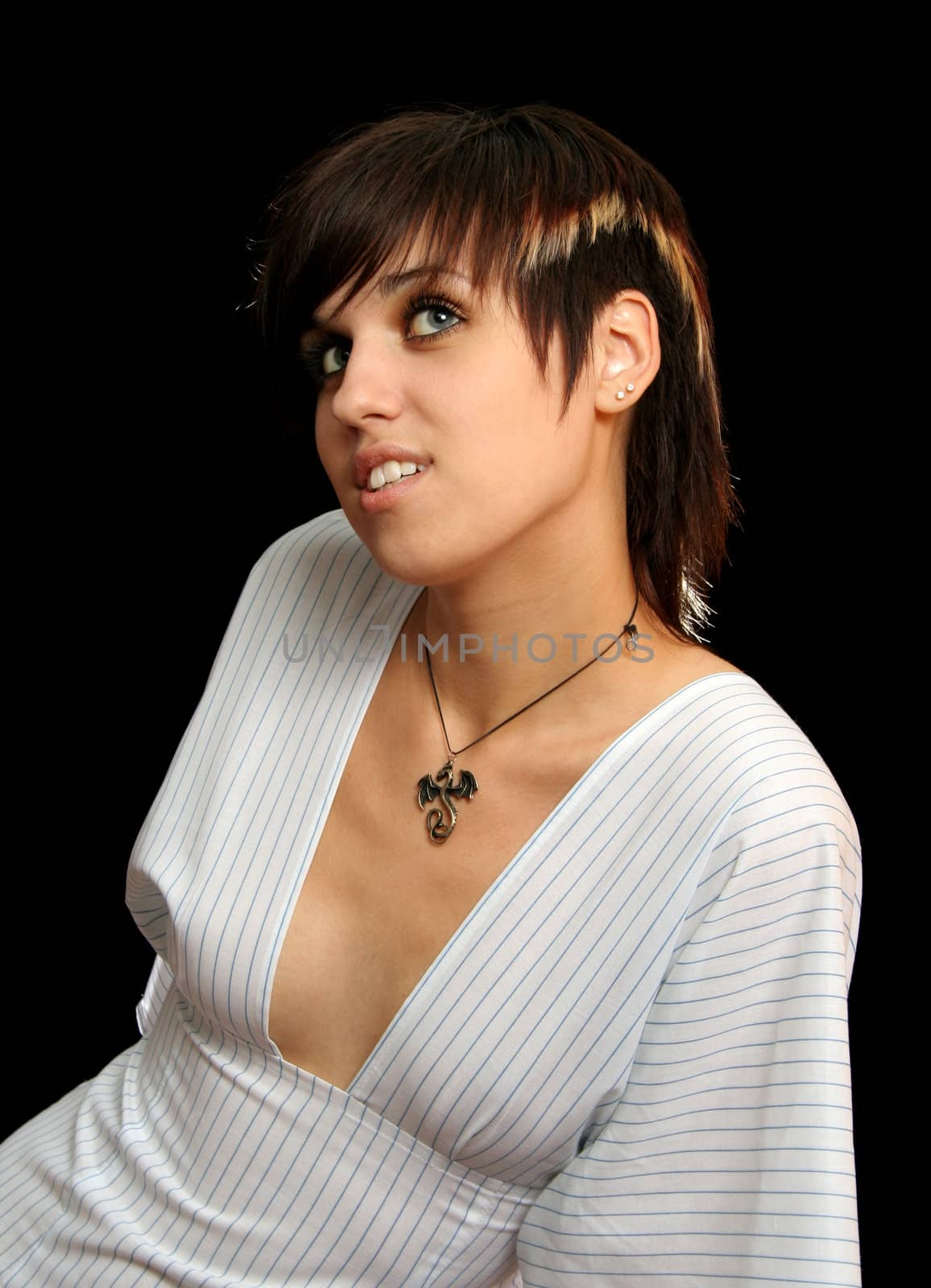 The young beautiful sensual girl in a white dress, isolated on black