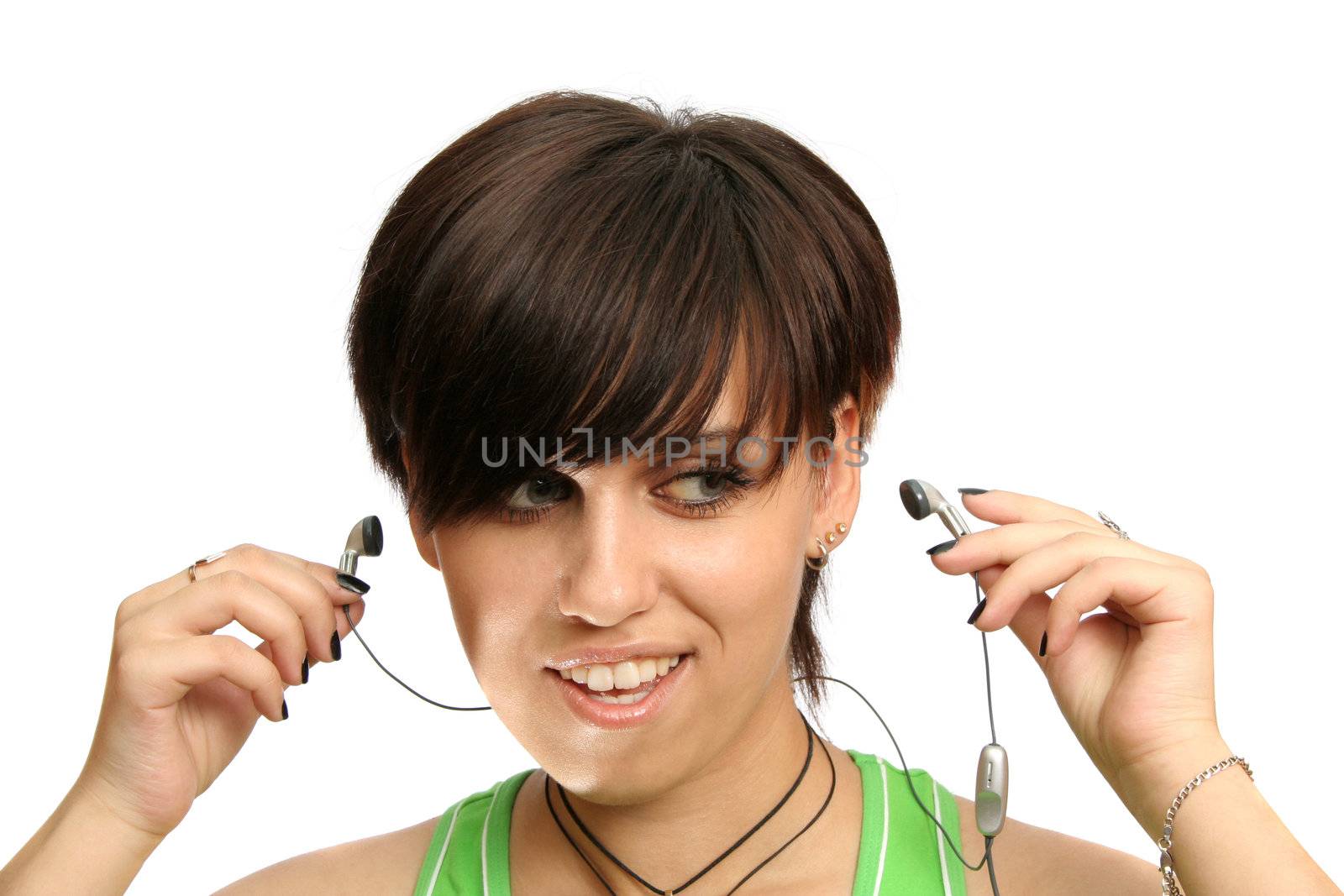 A smiling young girl with mobile's headphones, isolated on white