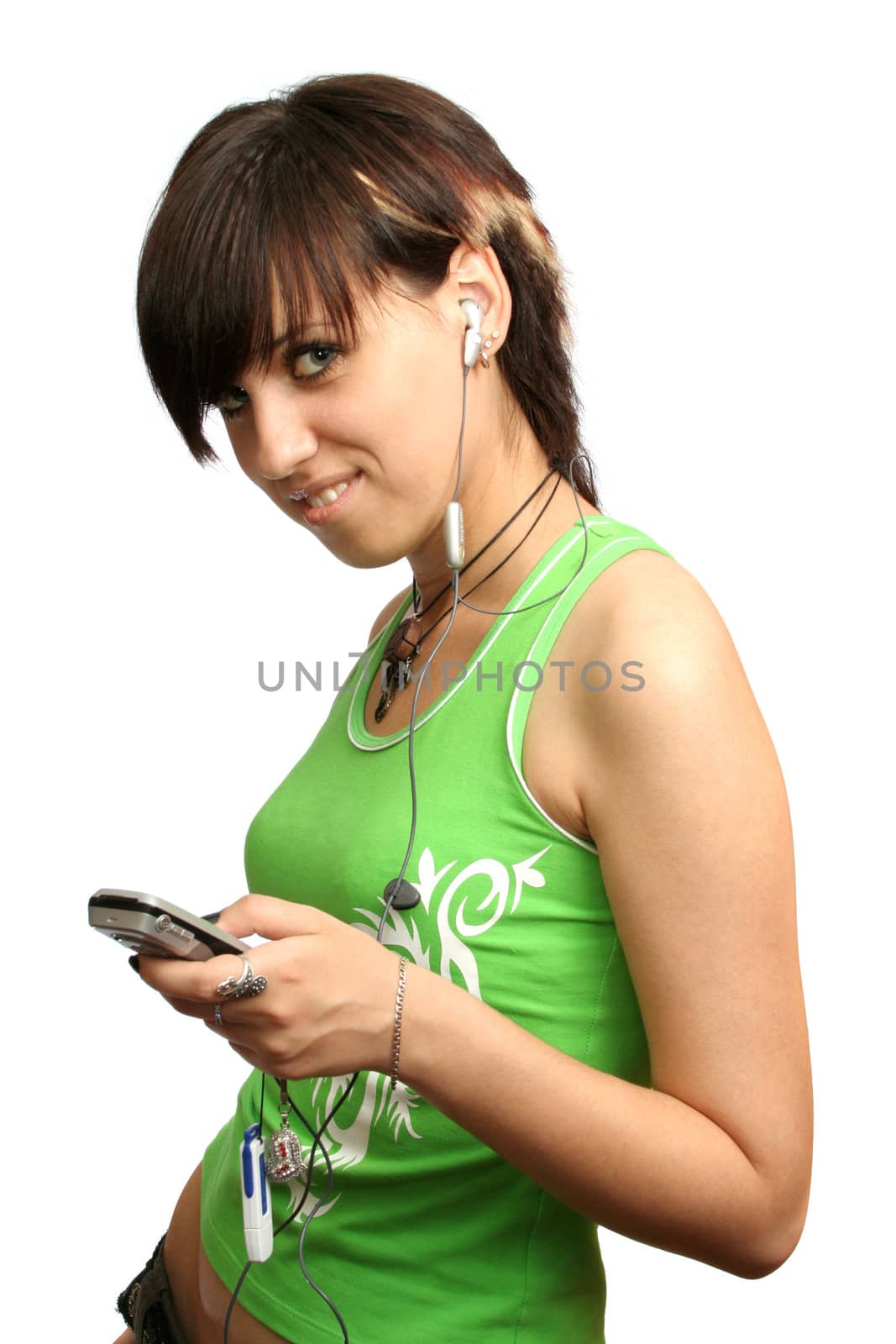 A smiling young girl with mobile's headphones, isolated on white