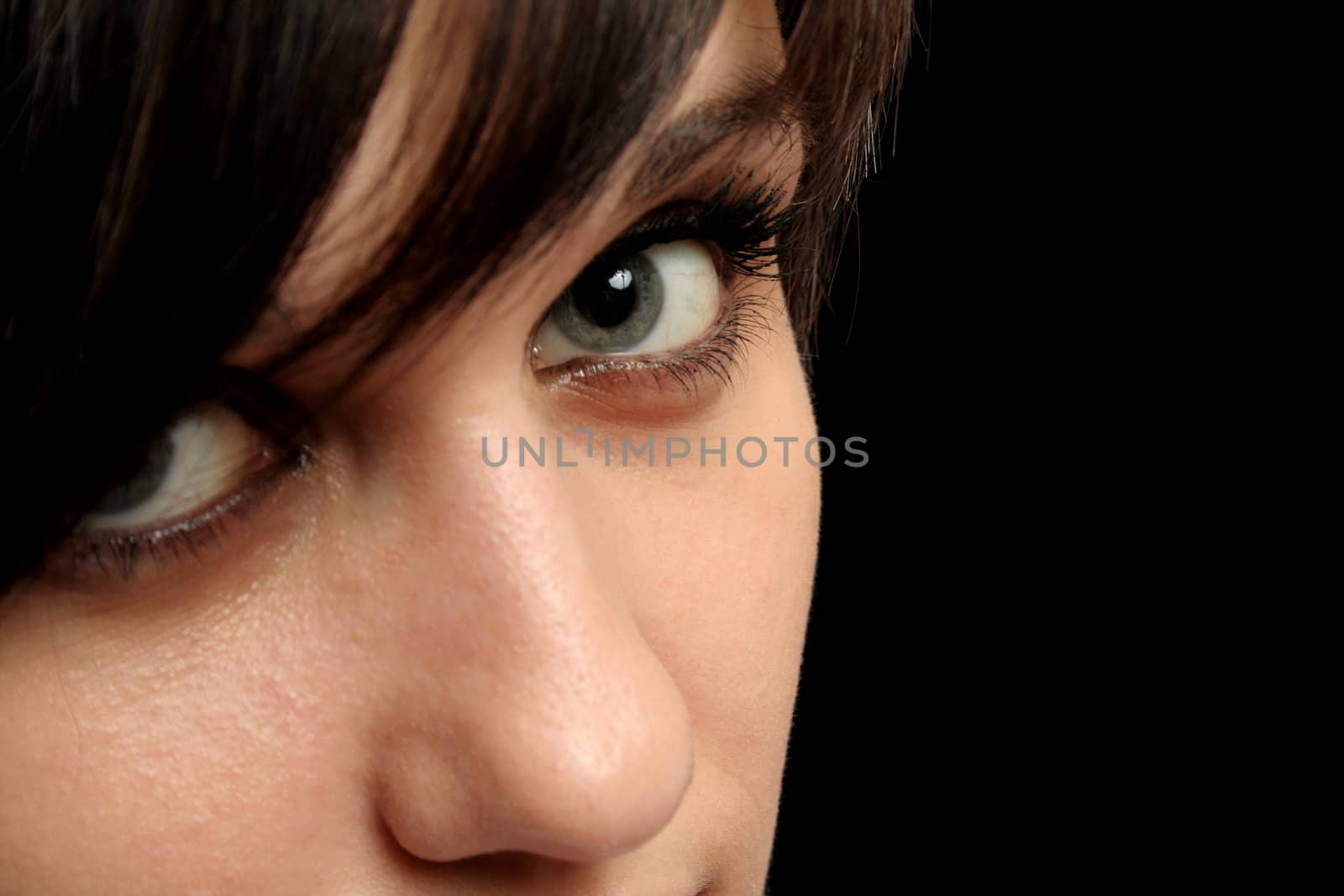 Steadfast sight of the young girl, isolated on black