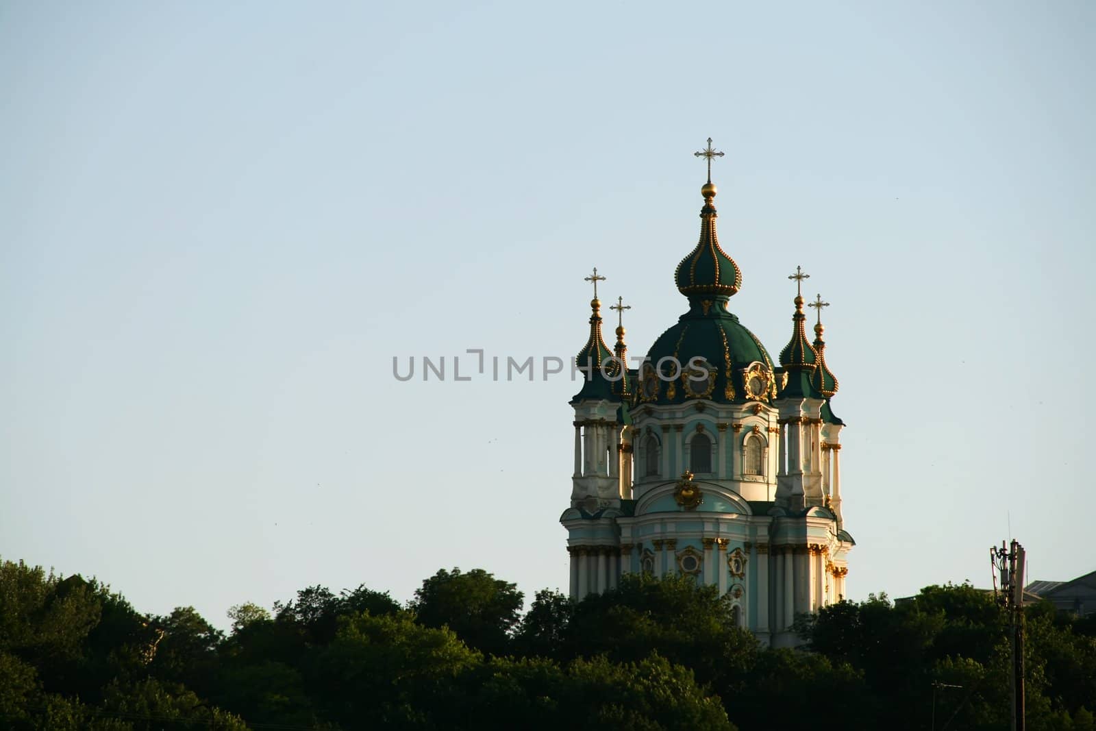 Andreevskaya church, Kiev, Ukraine, green trees on foreground