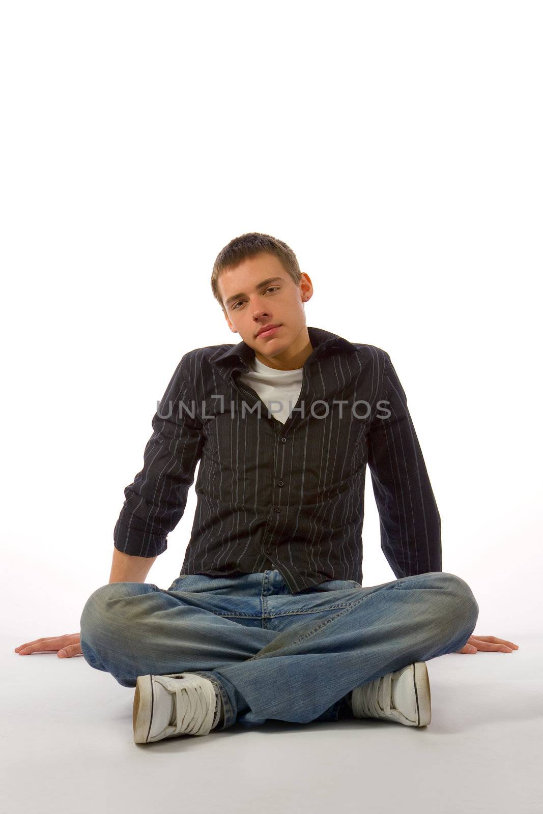 The beautiful young man posing in studio