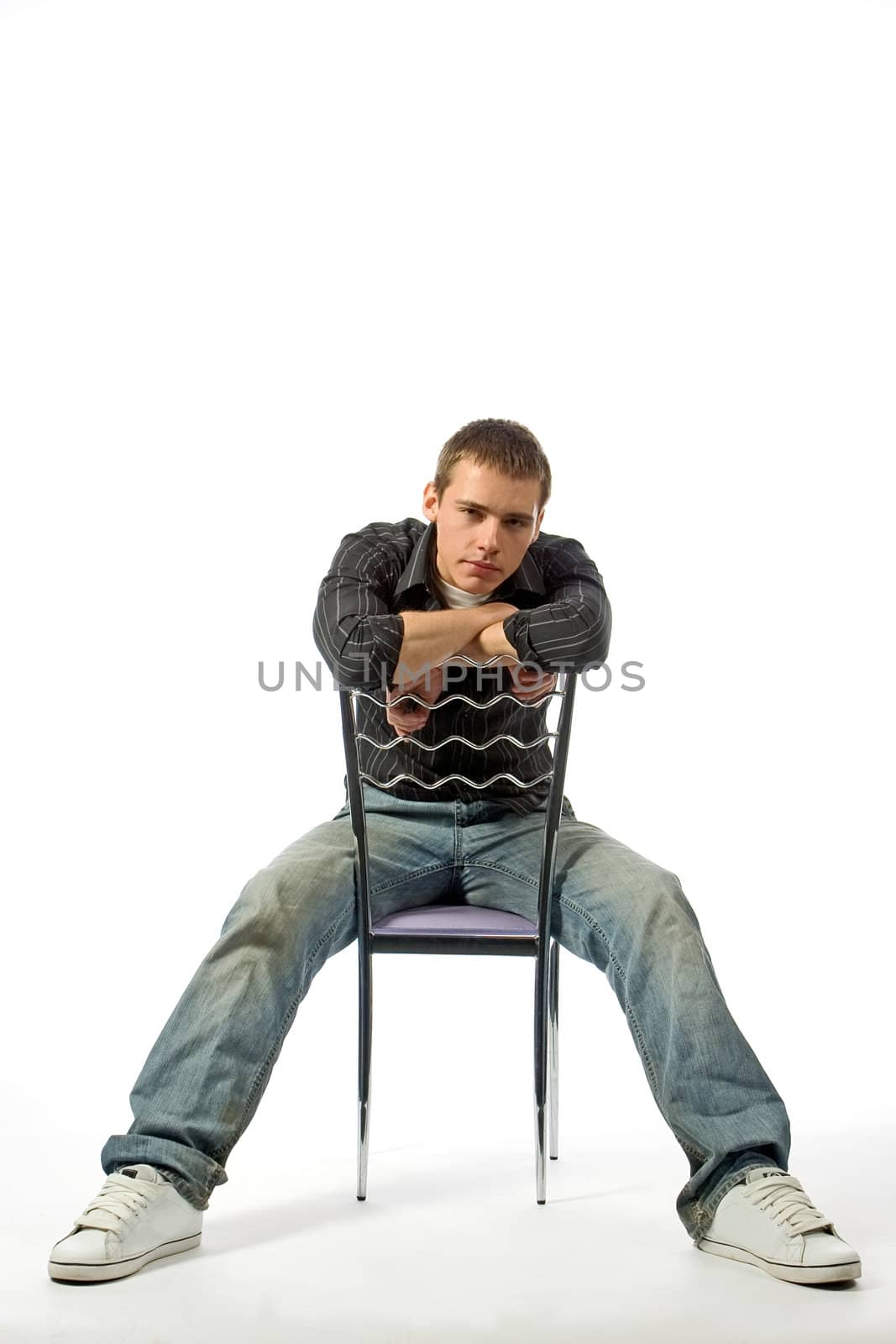 The thoughtful young man on a chair