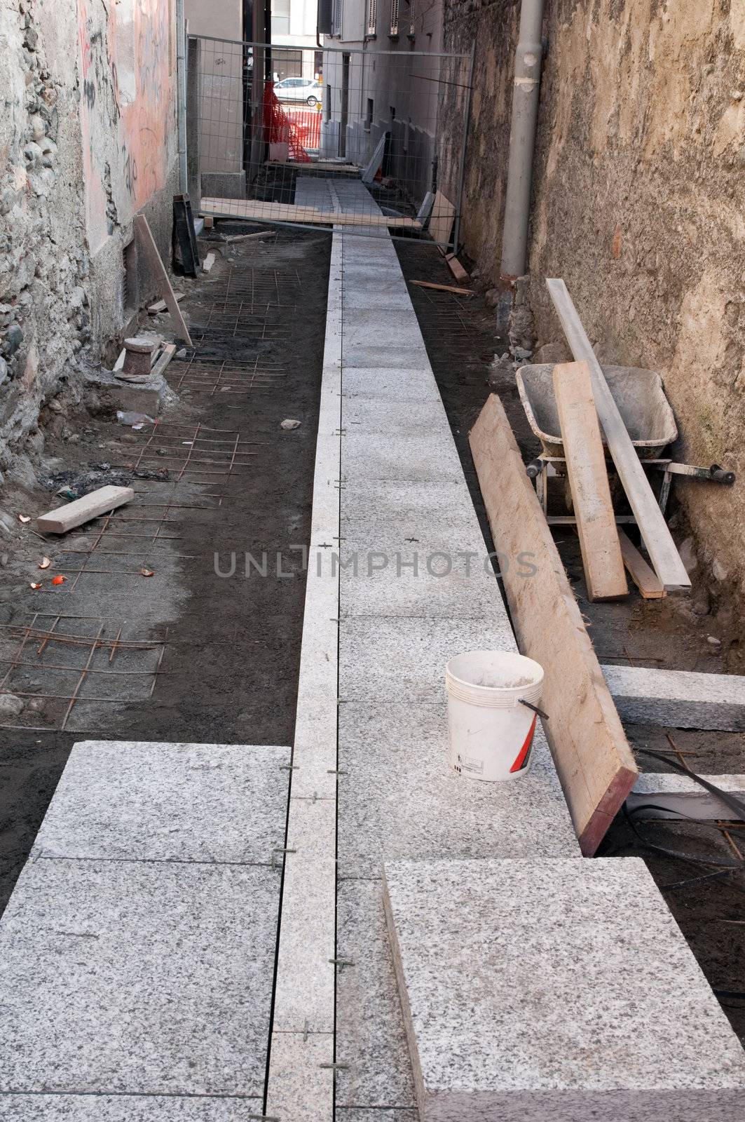 A yard in a urban center for the renovation of a street with stone slabs