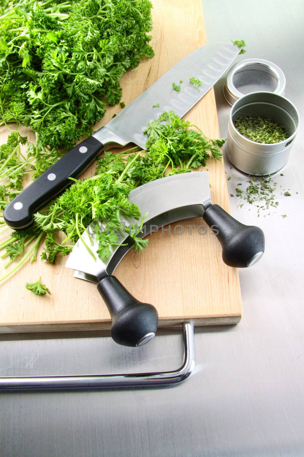 Fresh chopped parsley with cutting board on stainless steel