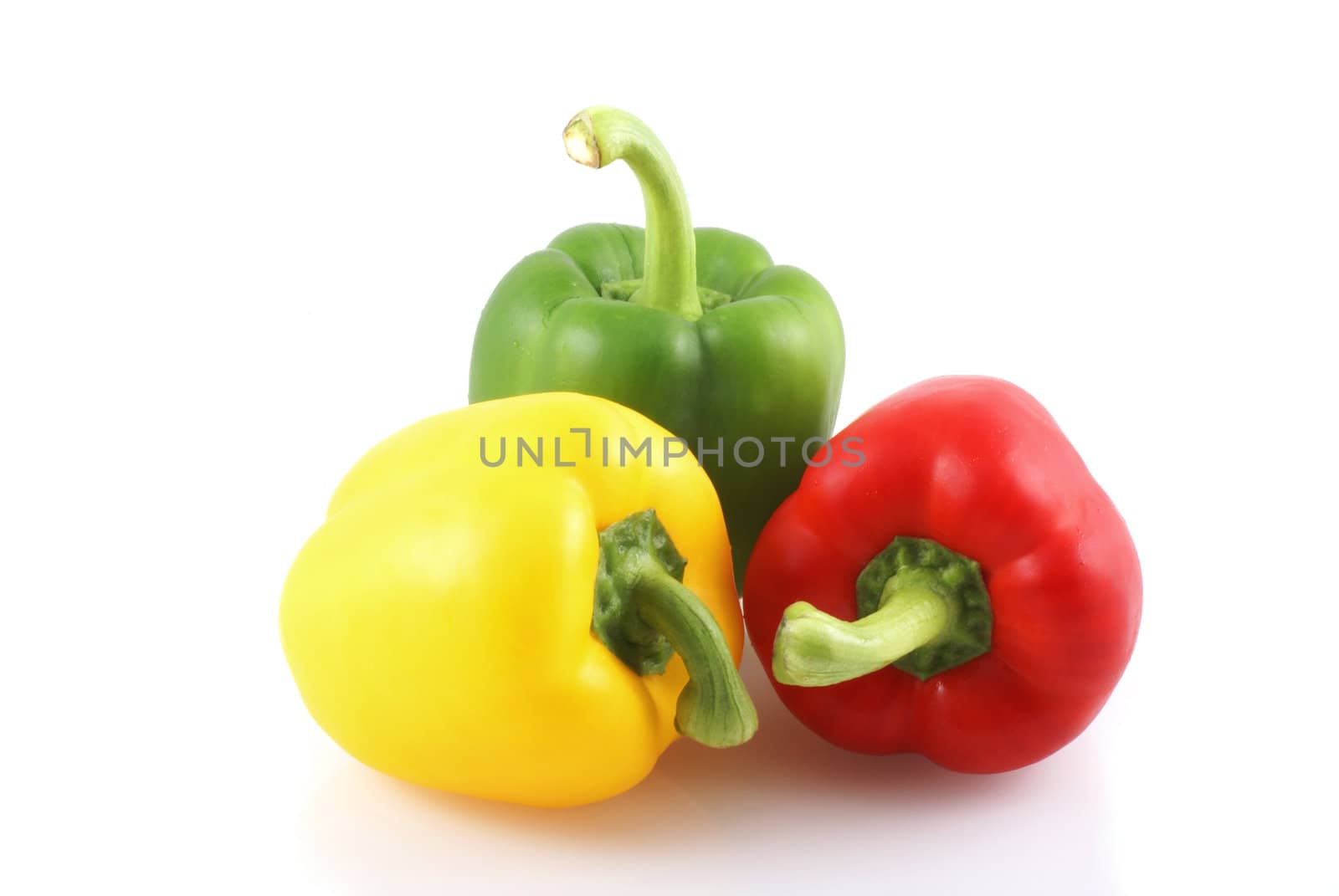 Three colors paprika isolated on a white background.