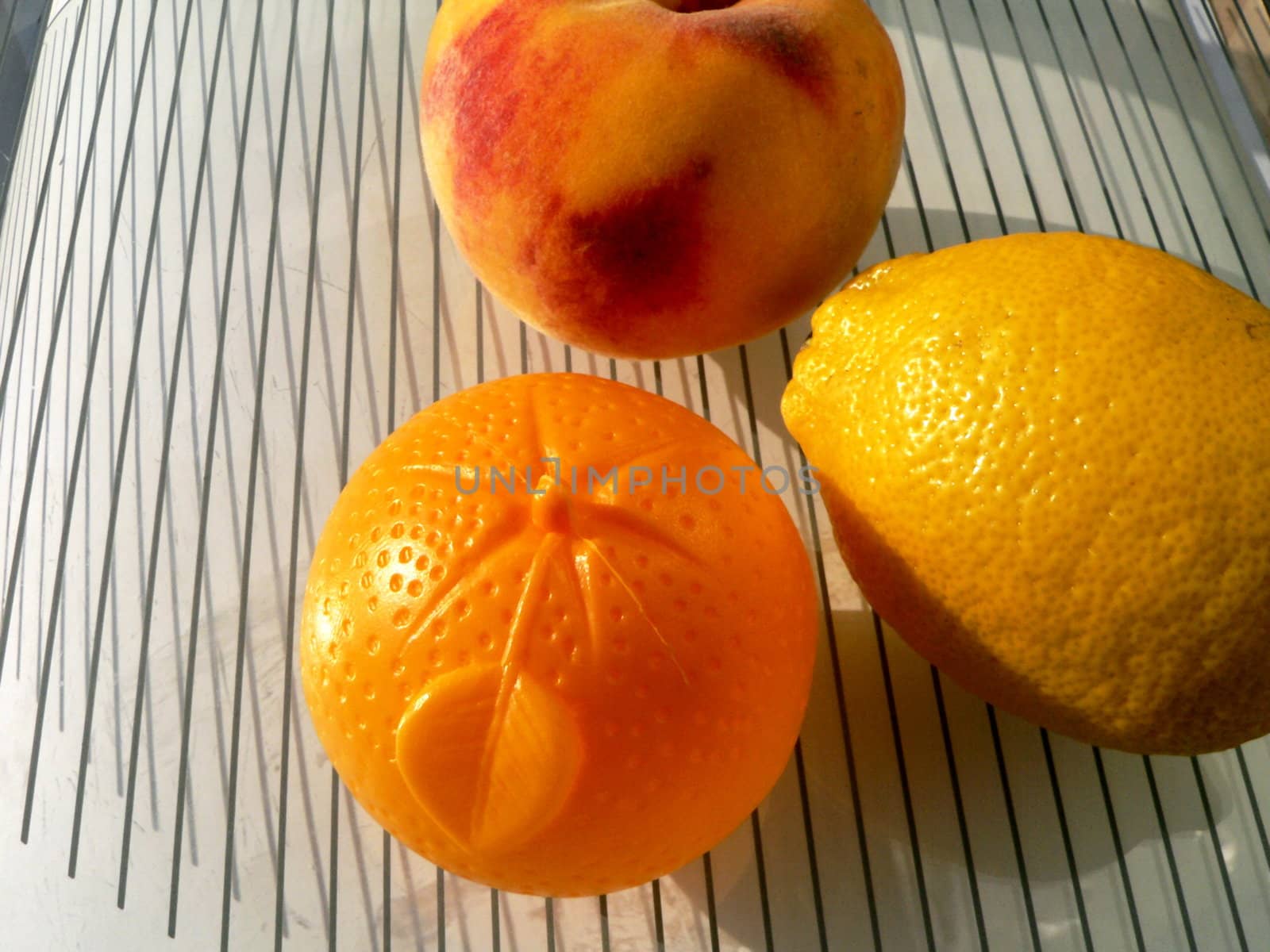 Lemon, peach and plastic orange