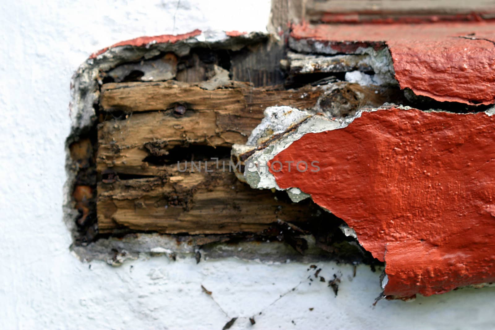 Old wood, with the red plaster falling off
