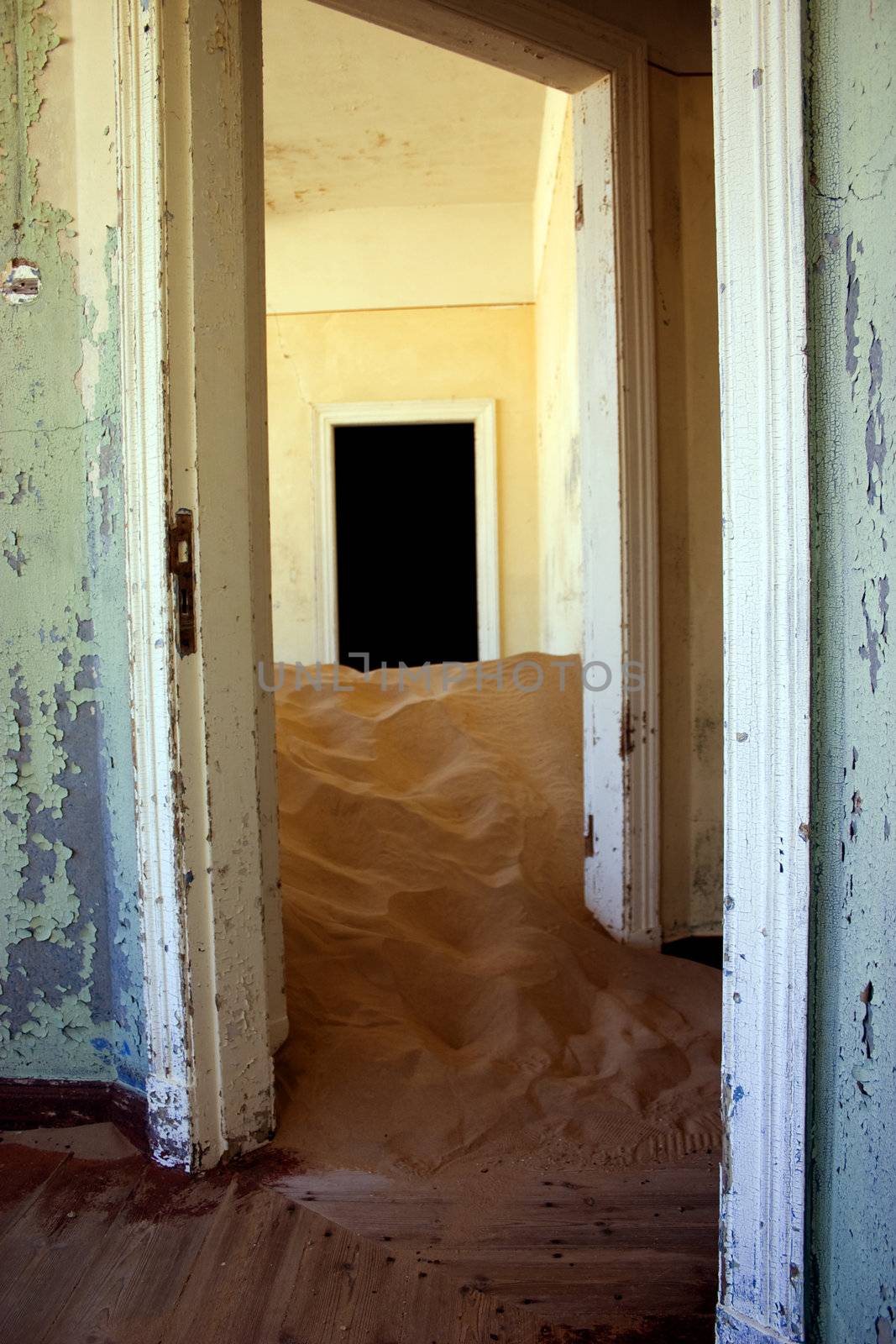 sand dune taking over the inside of a house in Kolmanskop Namibia 