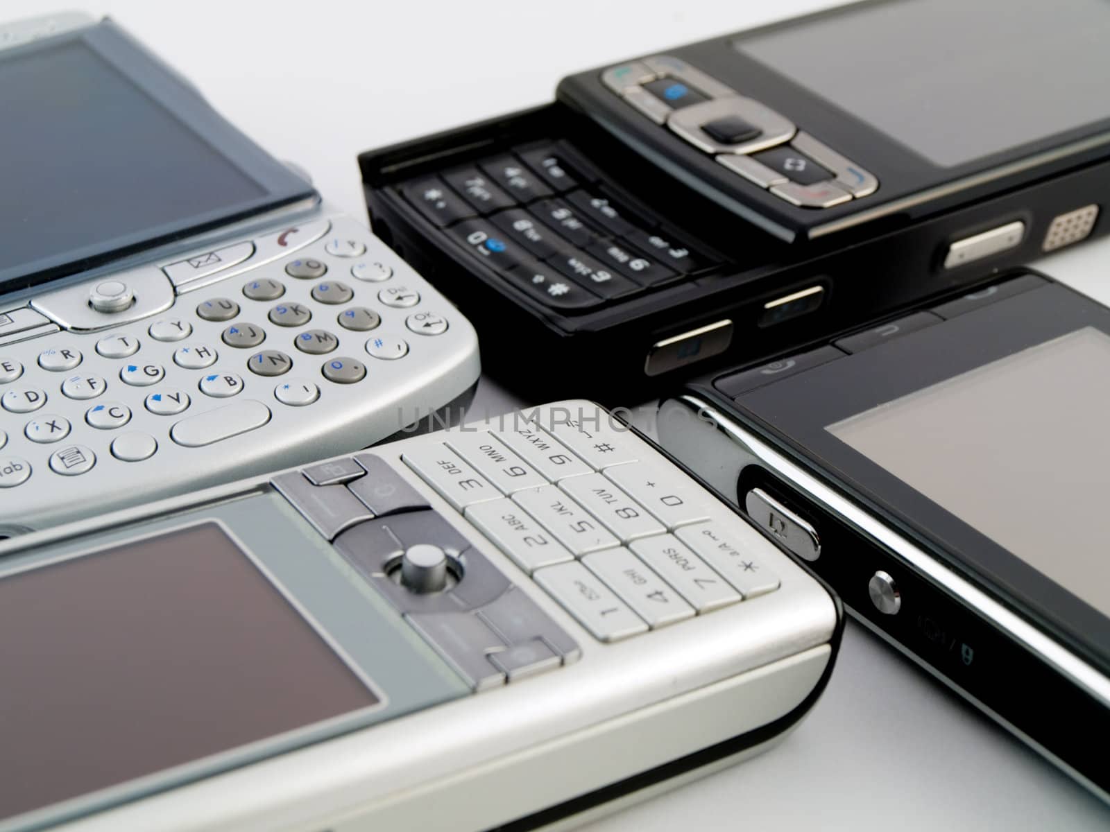 Stack Pile of Several Modern Mobile Phones PDA Cell Handheld Uni by bobbigmac