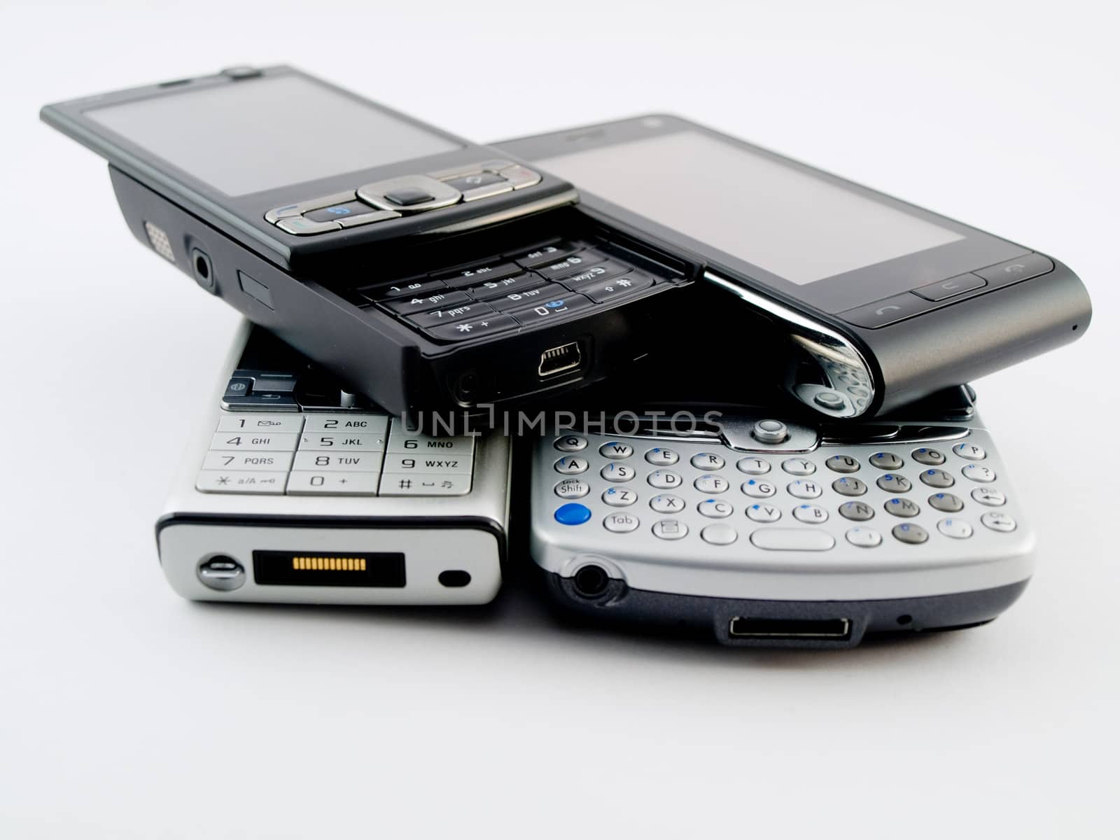 Stack Pile of Several Modern Mobile Phones PDA Cell Handheld Units Isolated on White Background