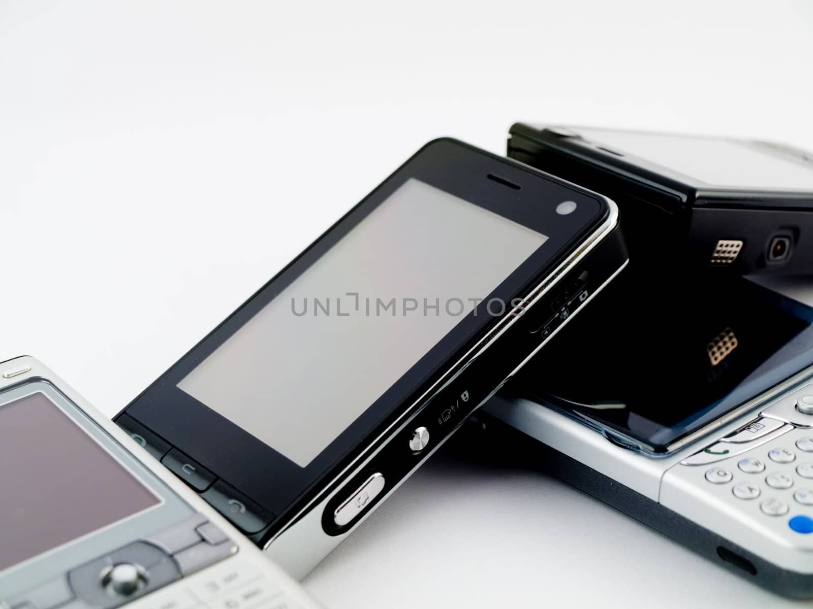 Stack Pile of Several Modern Mobile Phones PDA Cell Handheld Uni by bobbigmac