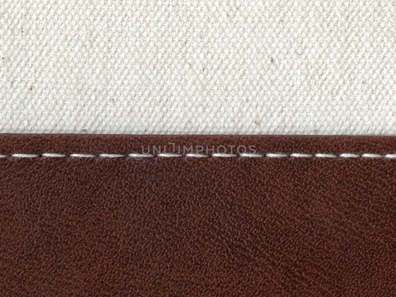 two textile materials jointed by white thread