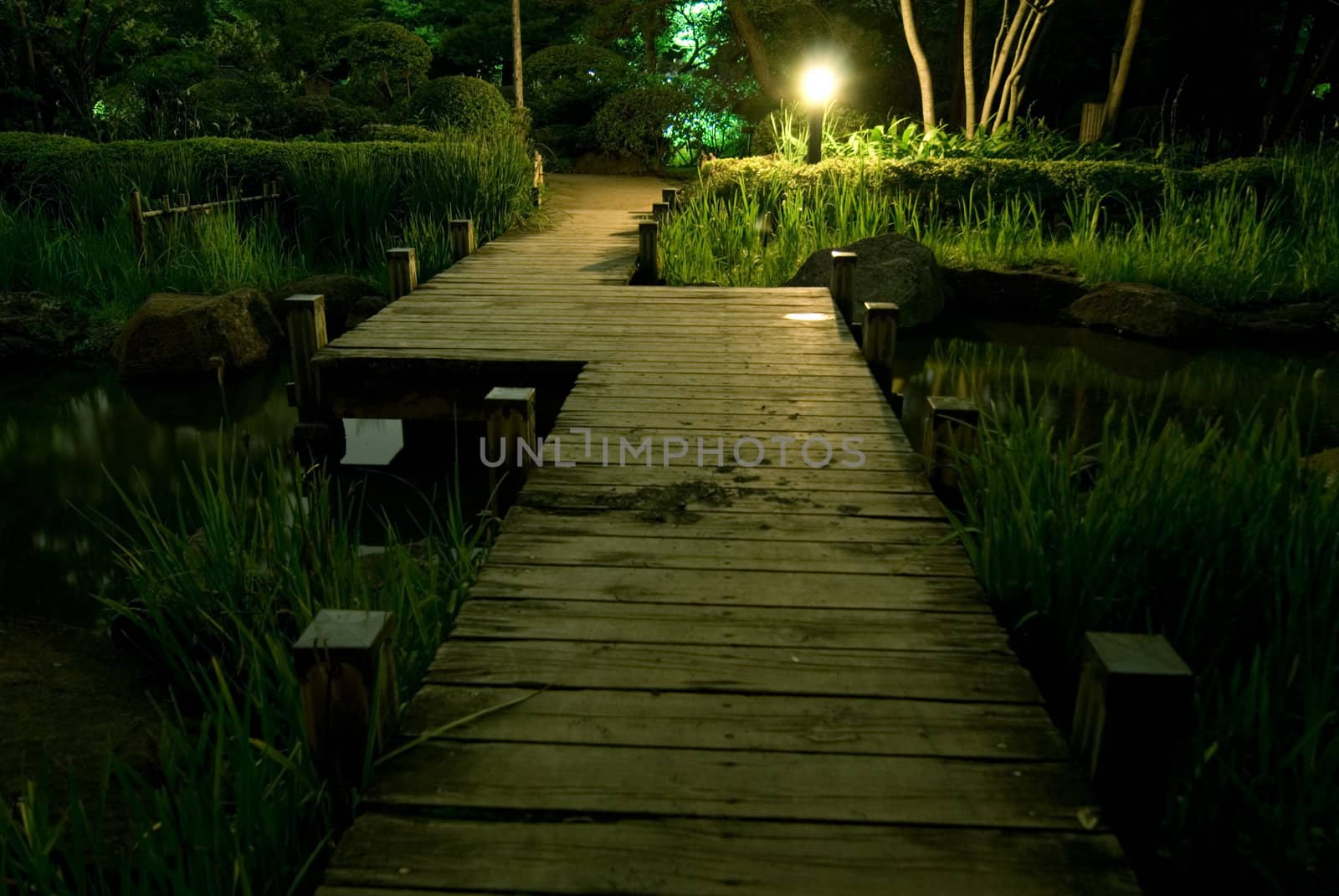 scenic wooden bridge in japanese garden at night