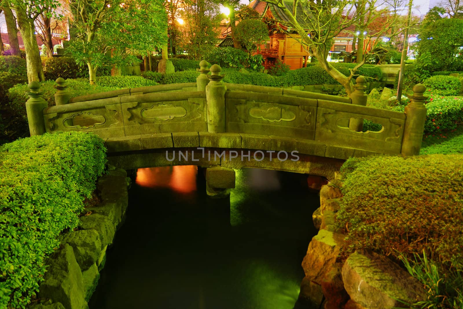  Japanese garden by night with traditional bridge over water pond at Asakusa, Tokyo, Japan
