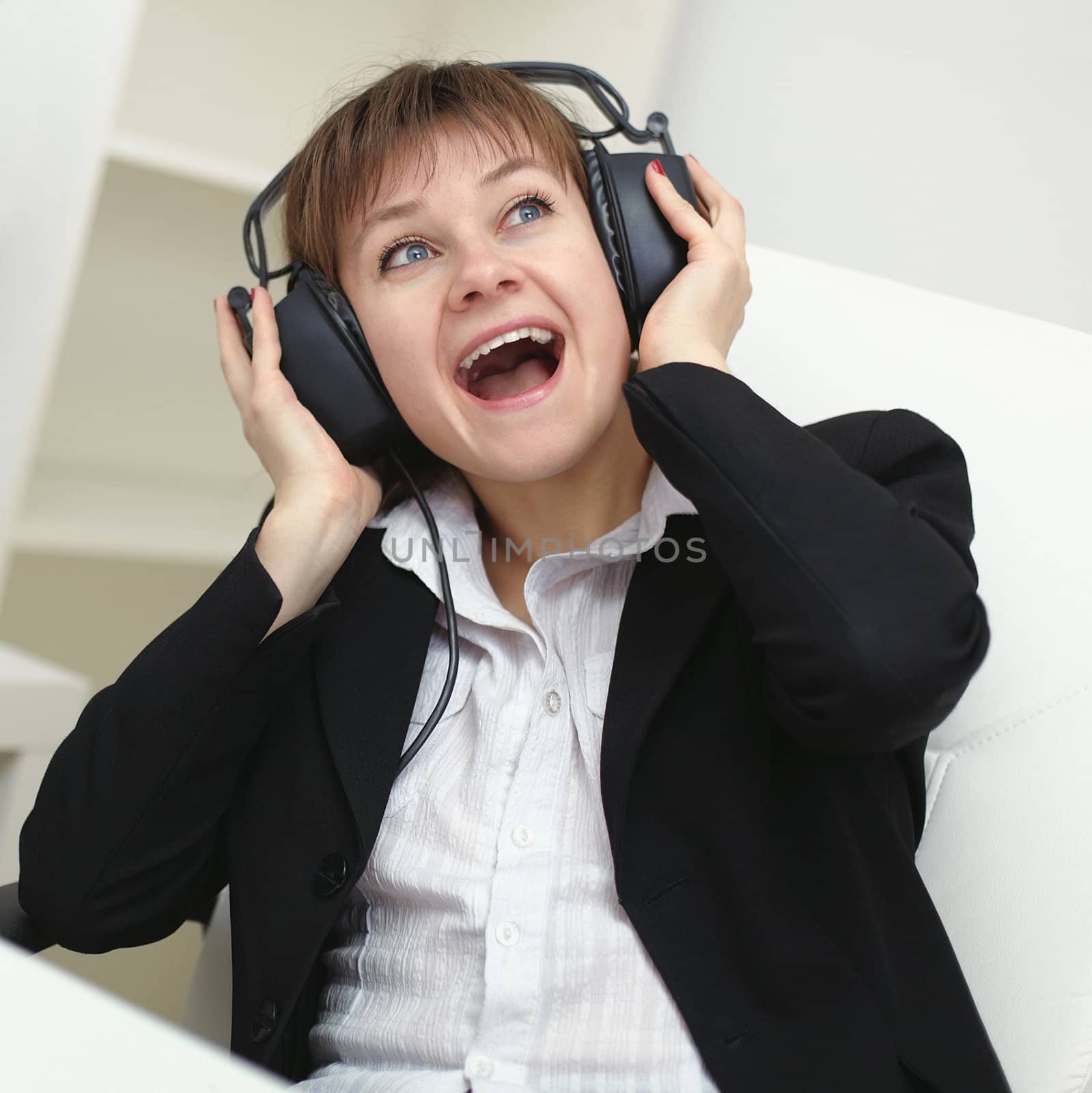 Cheerful woman with a big stereo headphones on his head