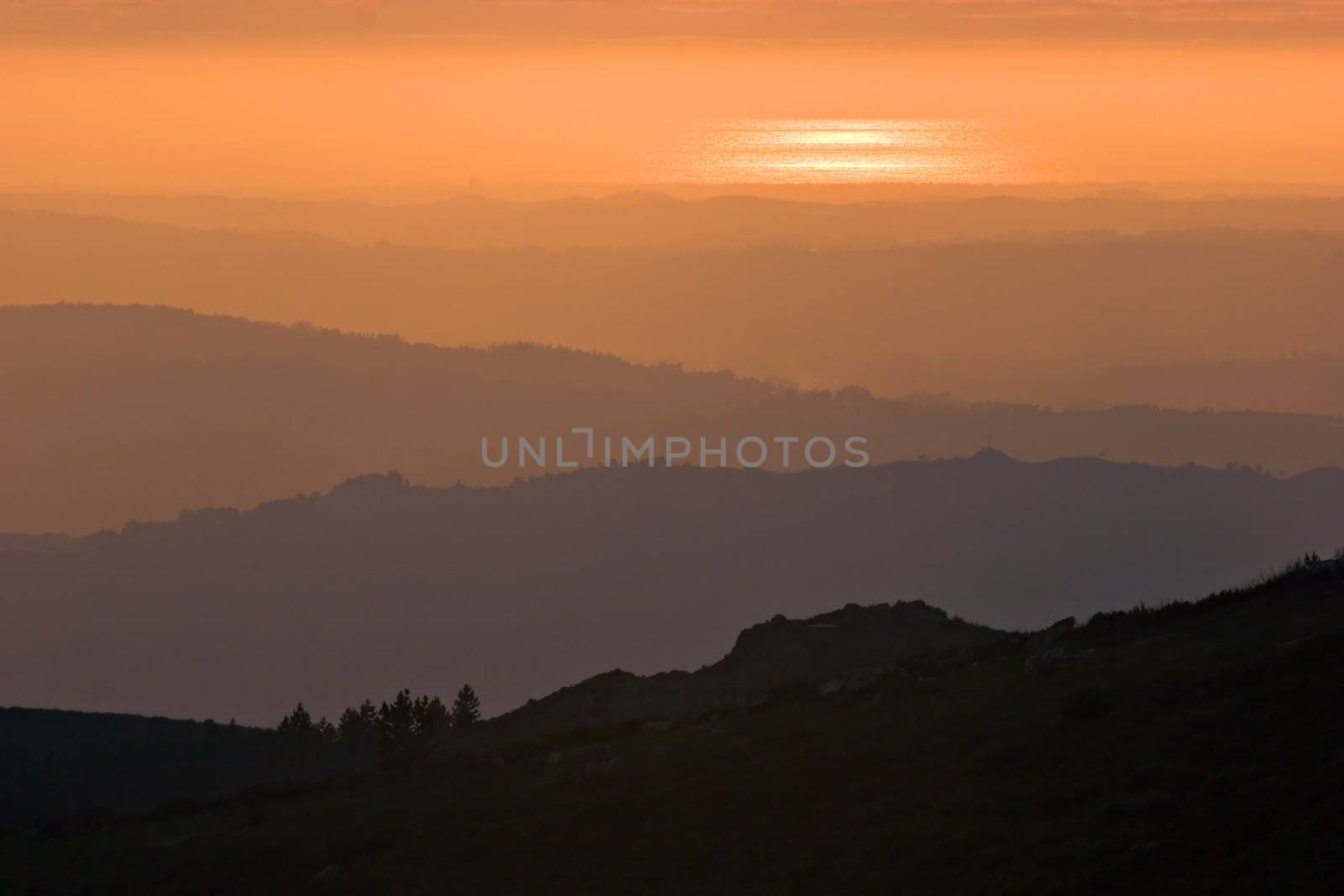 View over layered mountains on a beautiful Sunset. 