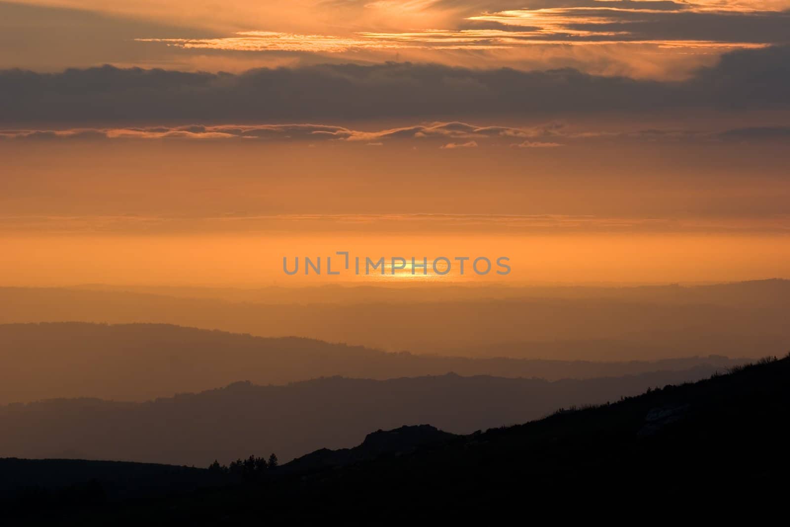 View over layered mountains on a beautiful Sunset. 