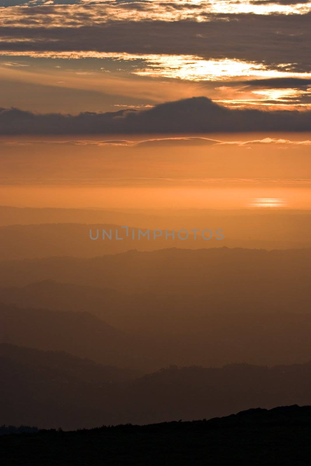 View over layered mountains on a beautiful Sunset. 