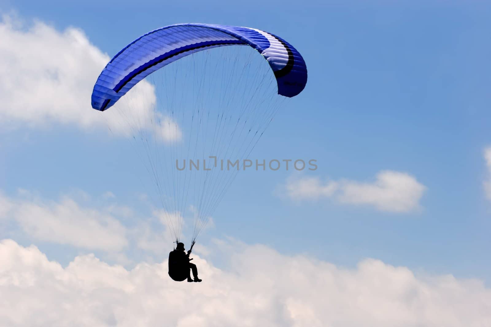 Paraglider in blue sky