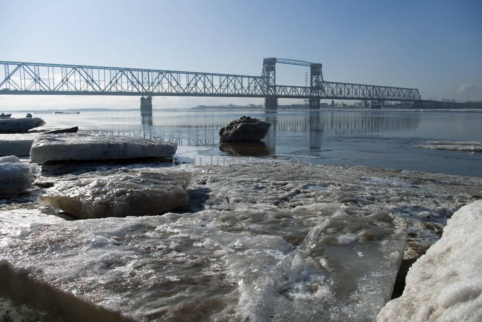 Railway bridge by springtime.Driving of ice goes On river