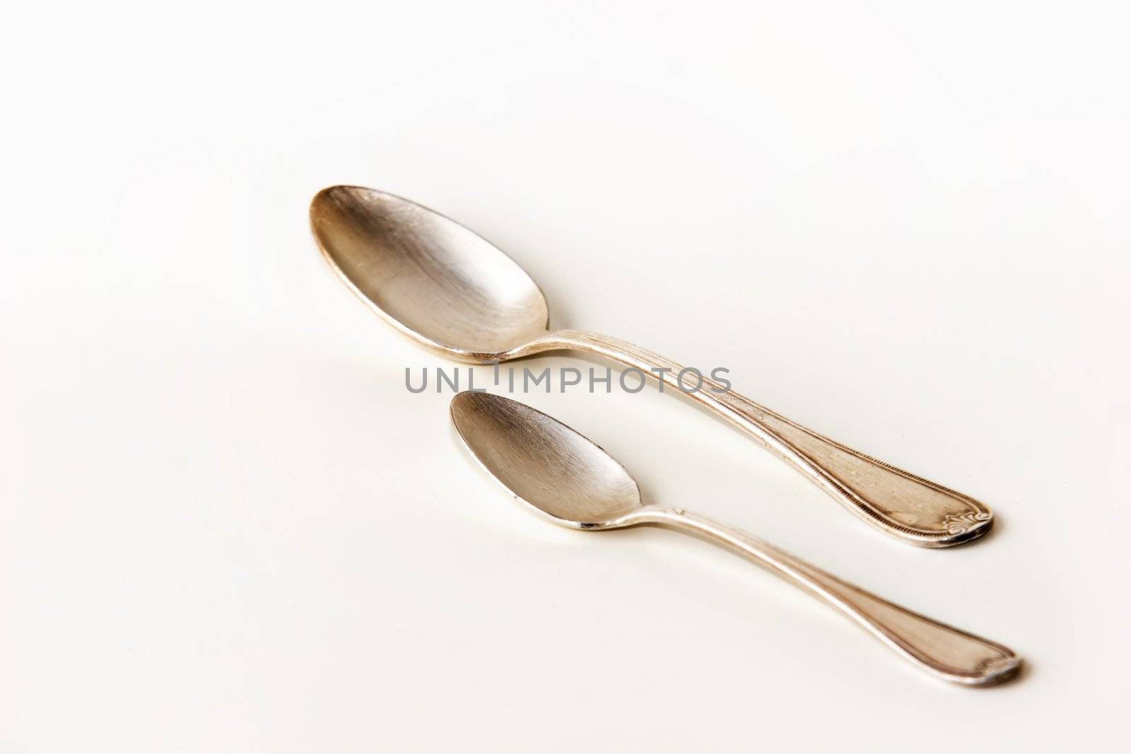 Silver spoons on white background