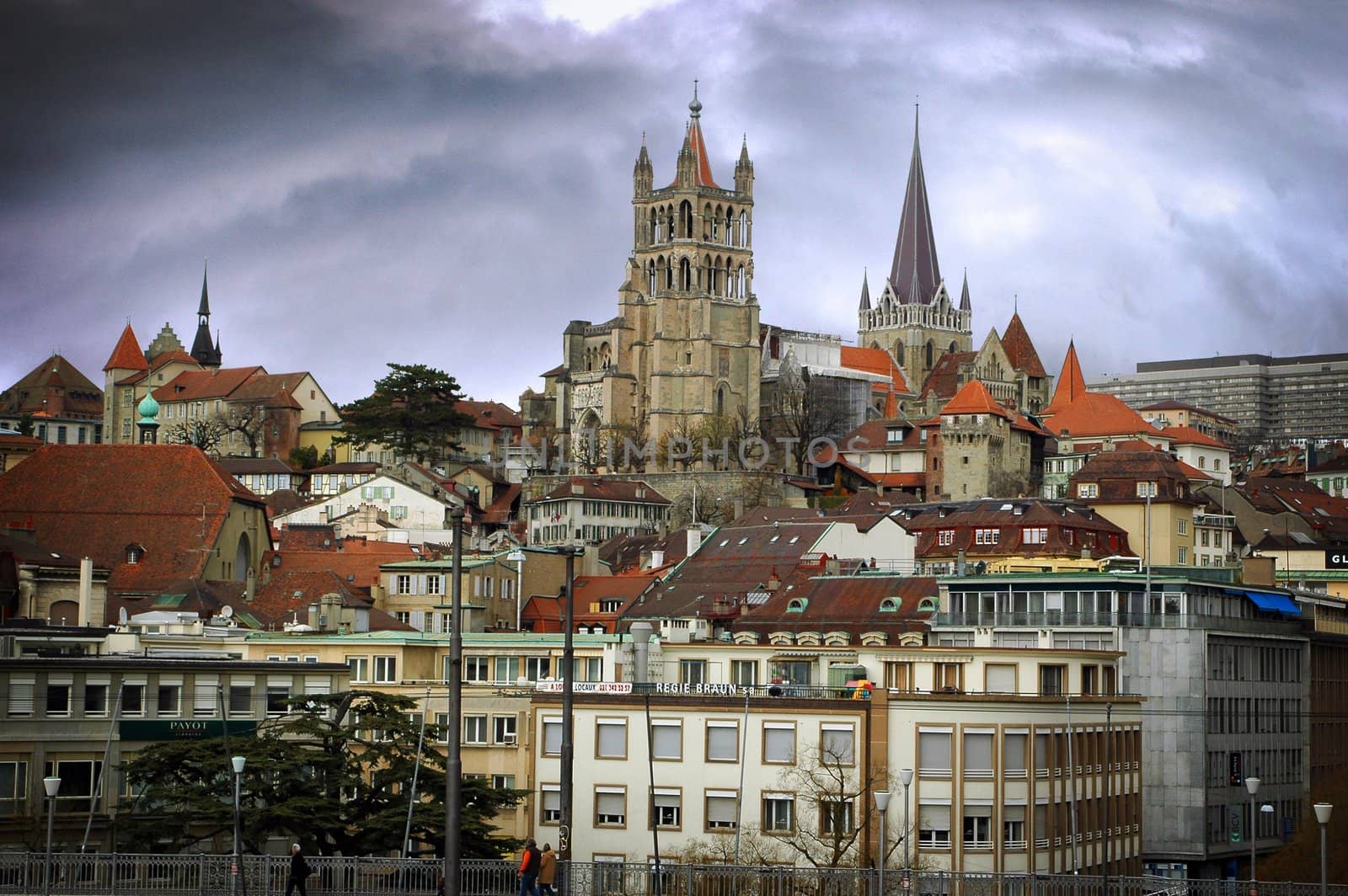 Landscape image of Lausanne showing steeples with a dramatic sky.