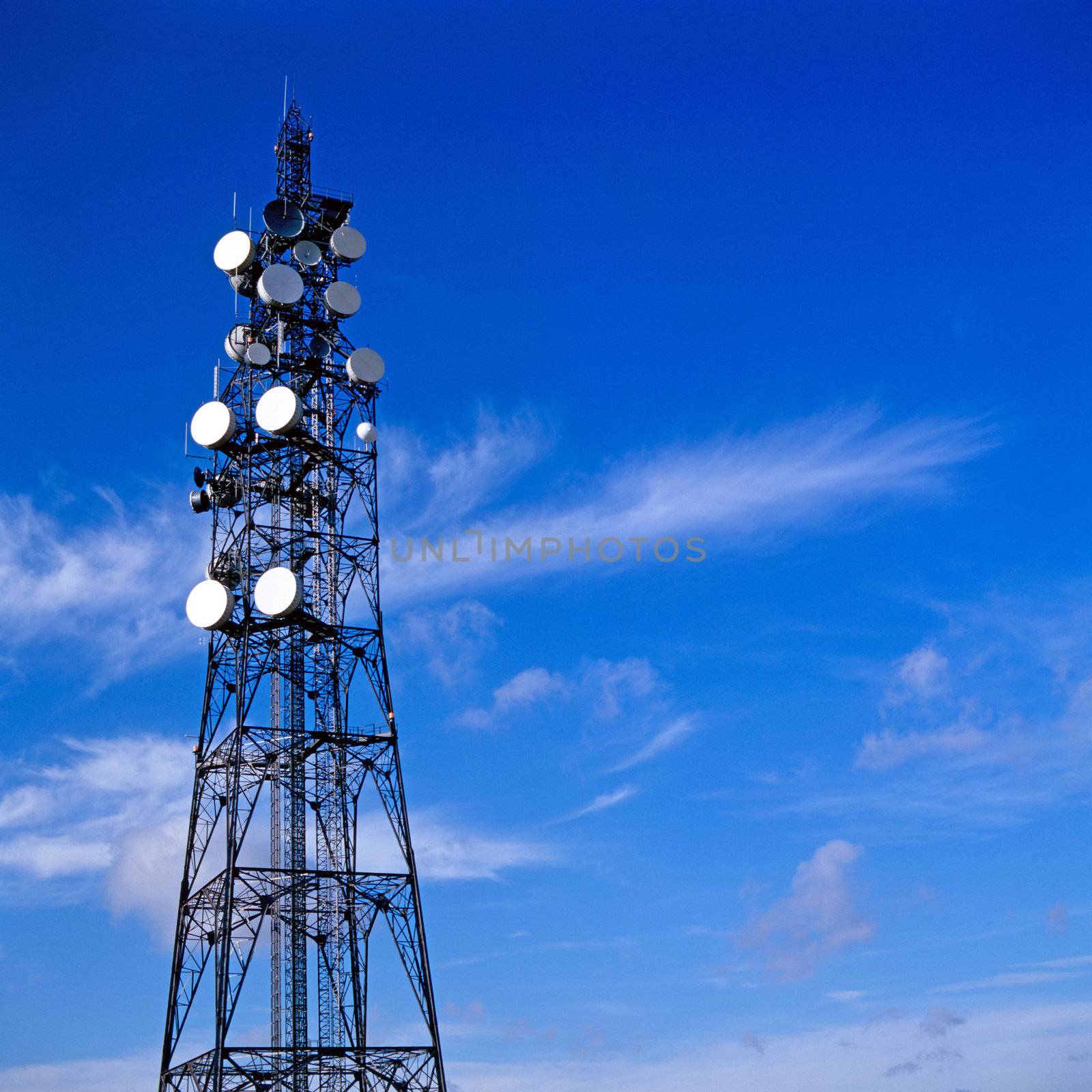 Telecommunication mast with blue sky background