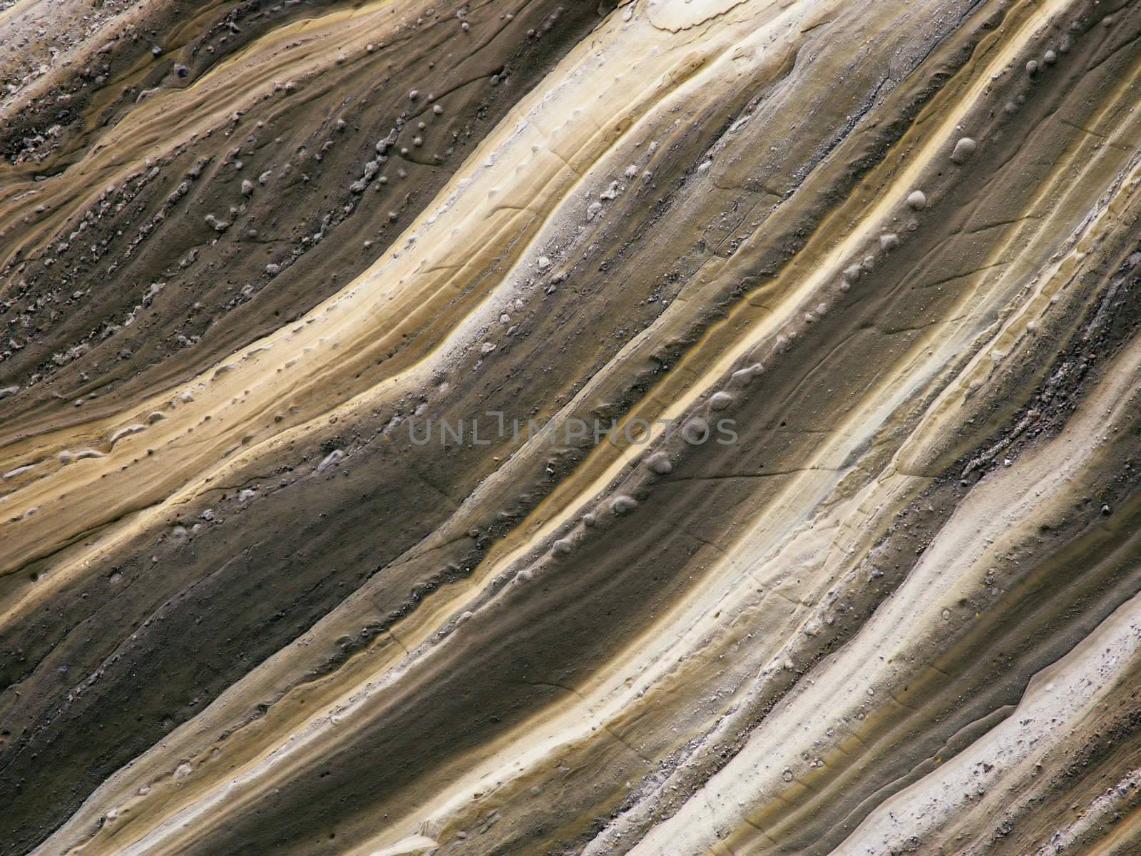 Background / textural image of a rock wall eroded by rain water.
