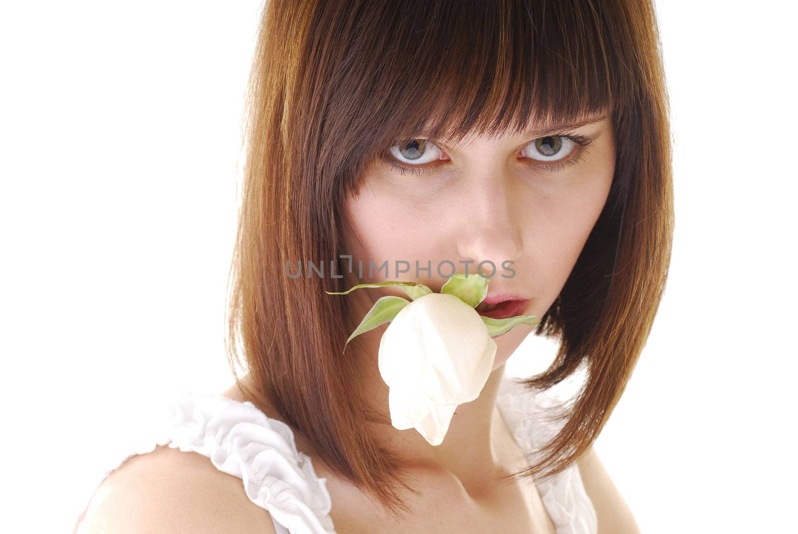 Young pretty woman with white rose in her lips