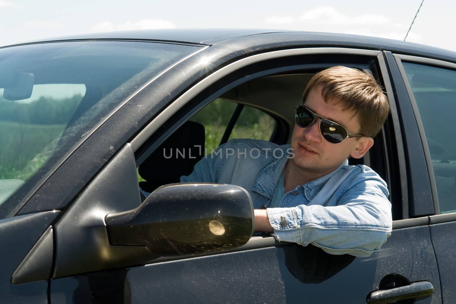 smiling young man in the car