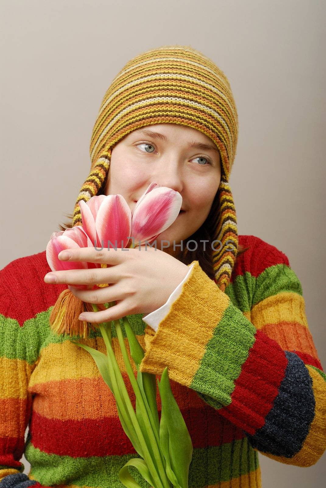 romantic girl in yellow cap with tulips
