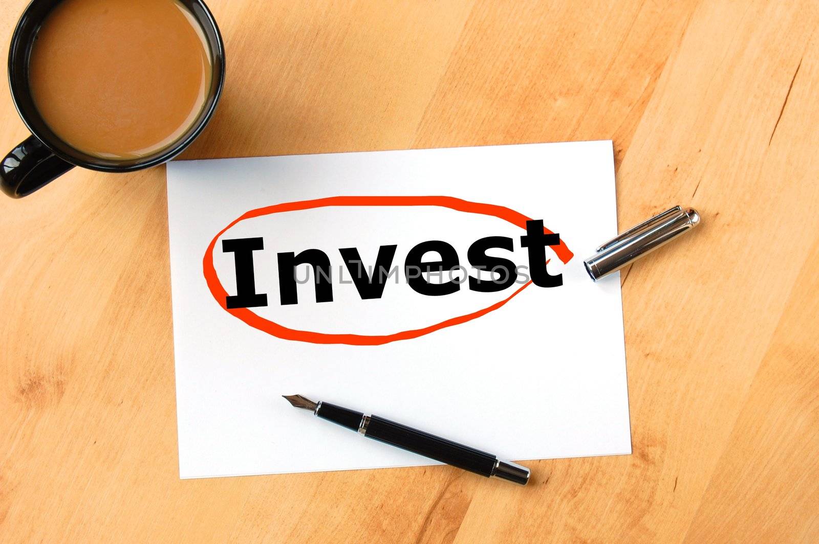 investment business concept with pen paper and cup of coffee