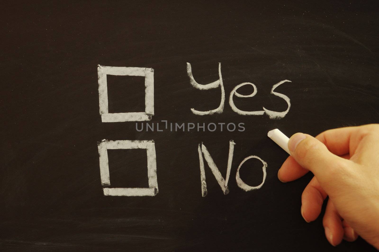 vote yes or no written on chalkboard or blackboard