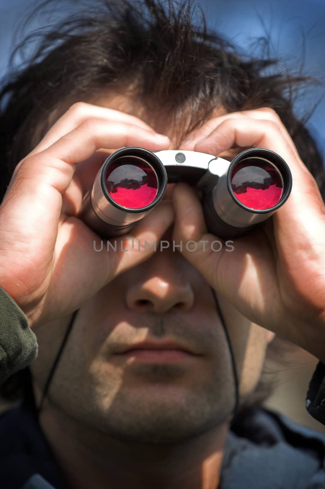 Man look through the  binoculars
