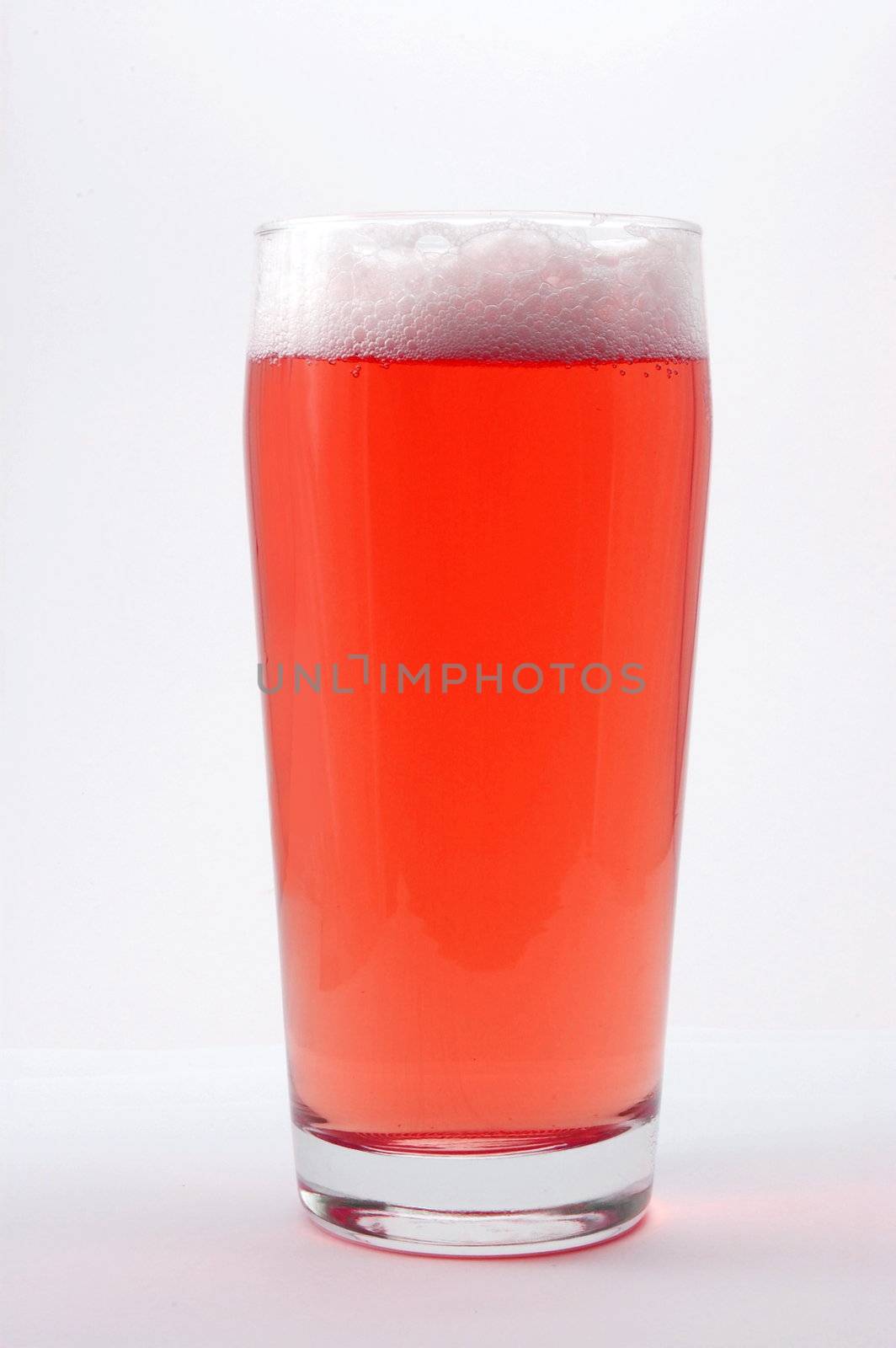 colored drink with foam isolated on white background