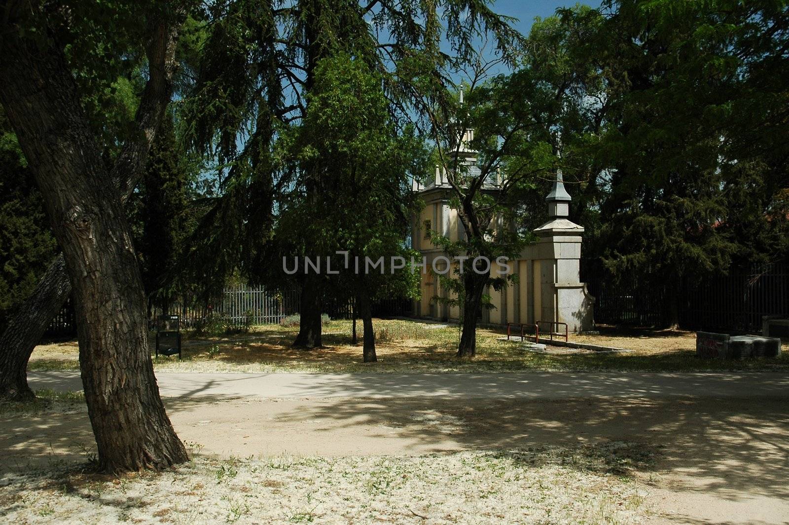 Madrid park with white chapel, trees, horizontally framed shot