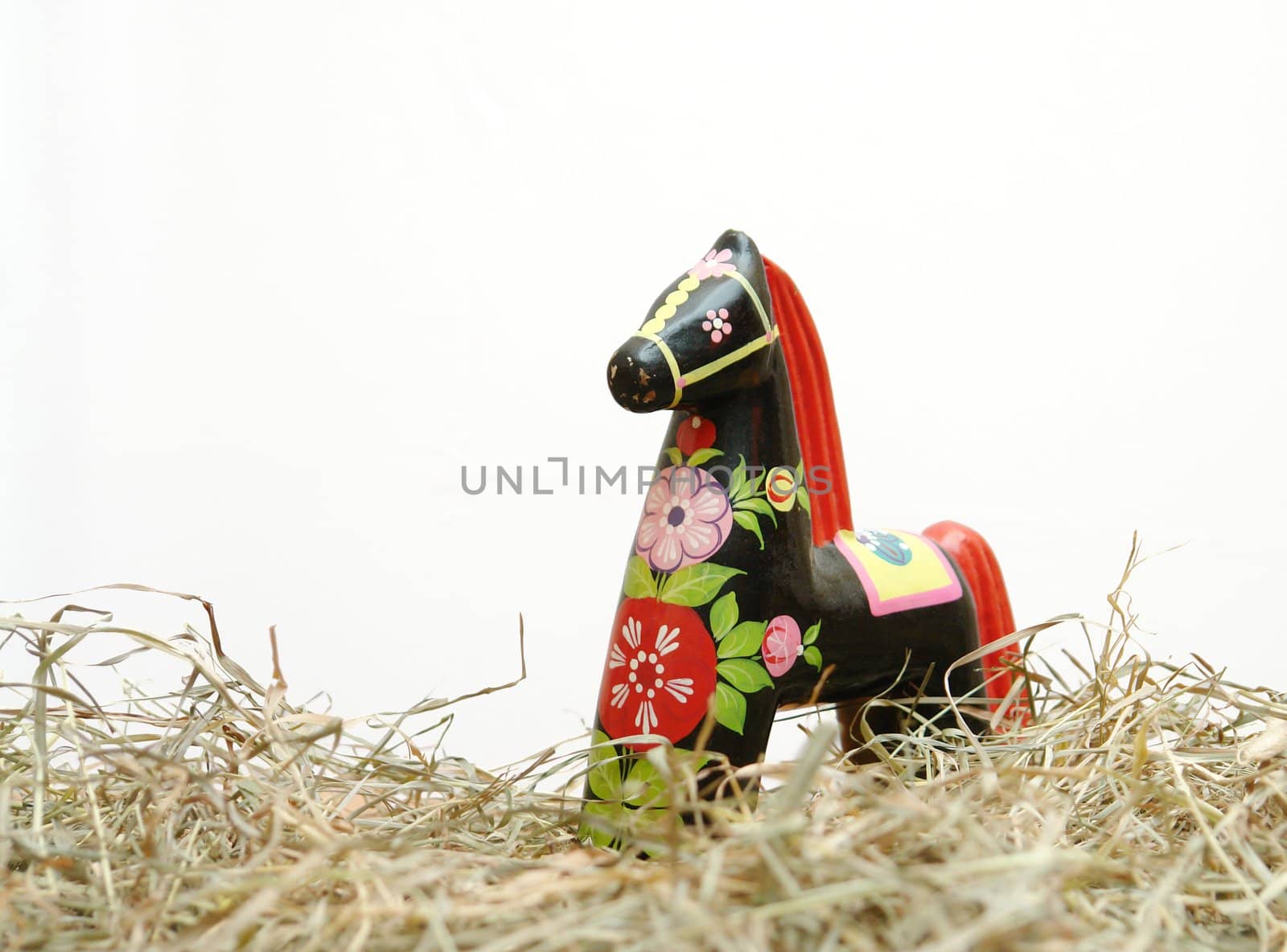 Hohloma horse stasnding in hay on a white background