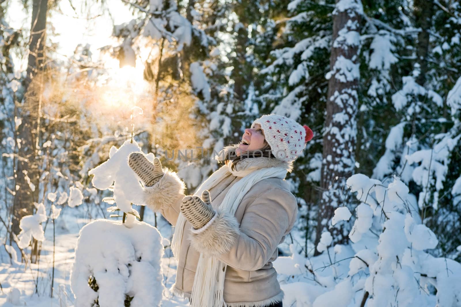 Happy middle-aged women having fun on winters day in forest.