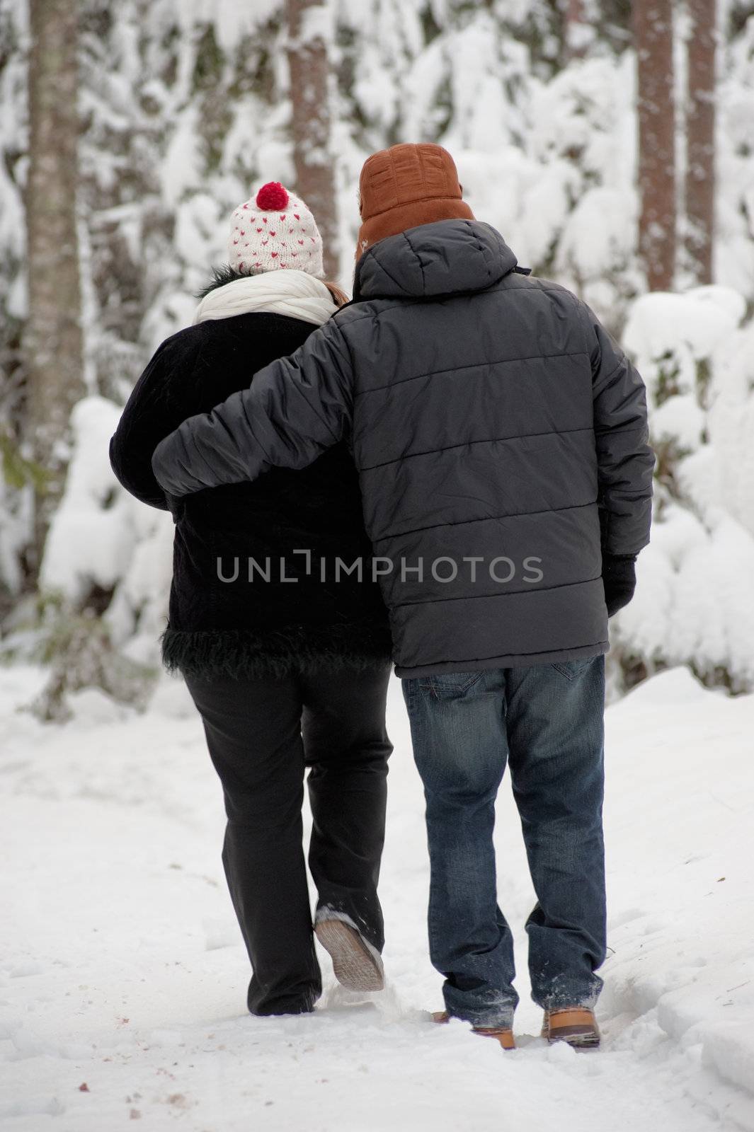 Happy middle-aged couple walking on a winter day 
