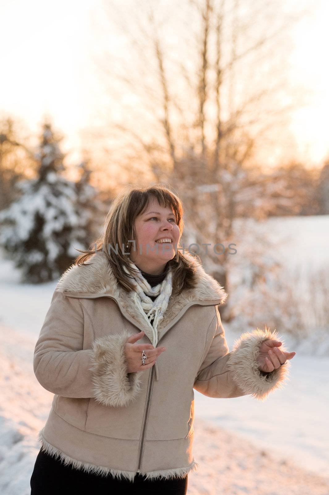 Happy middle-aged women having fun on winters sunset.