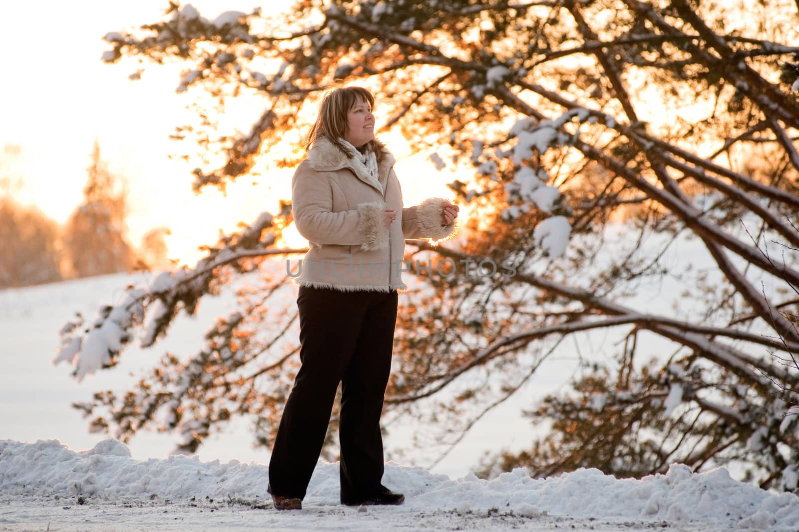 Happy middle-aged women having fun on winters sunset.