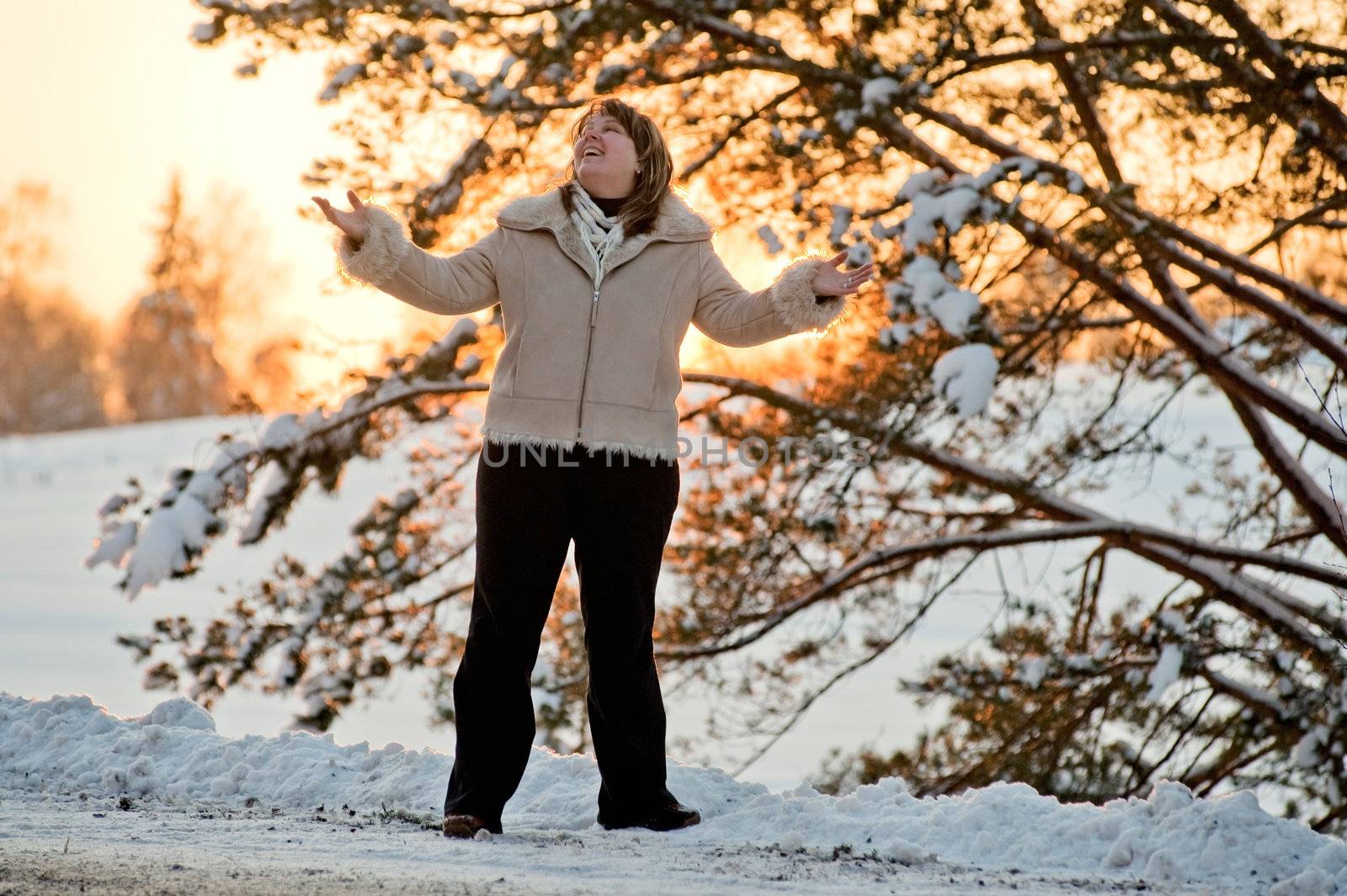 Happy middle-aged women having fun on winters sunset.